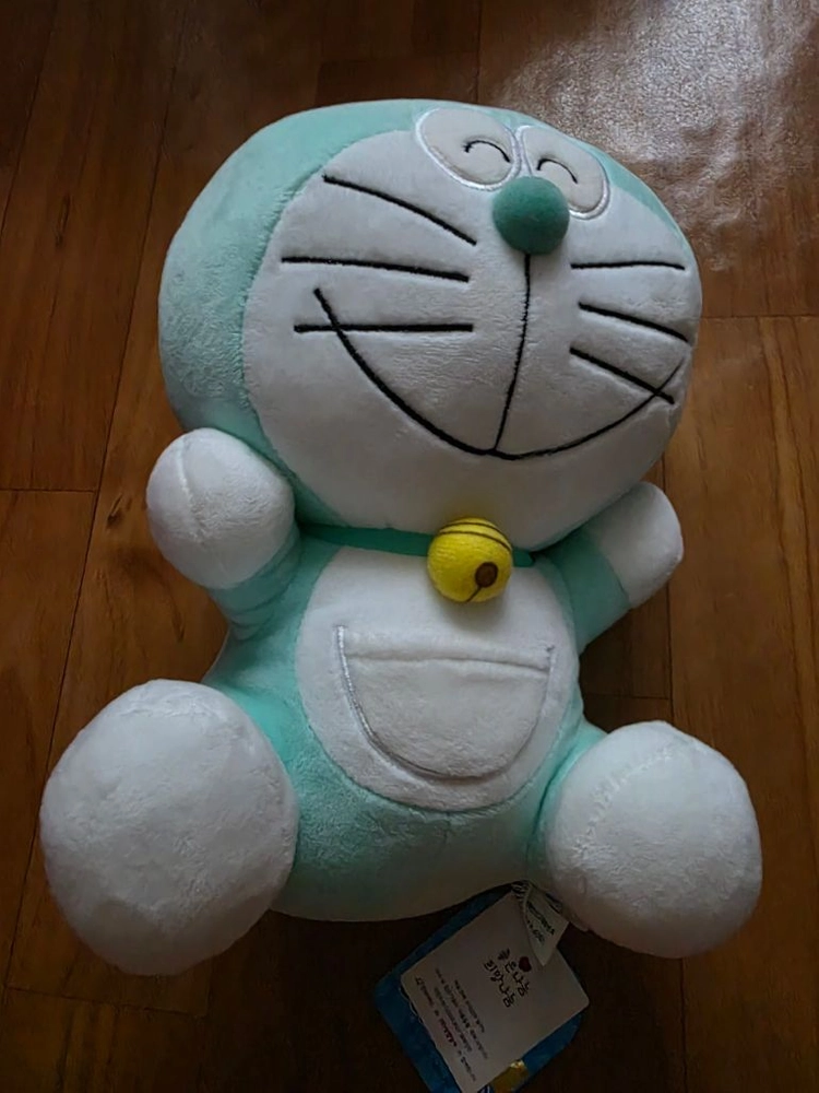 민트색 도라에몽 웃는 얼굴 봉제인형 이미지